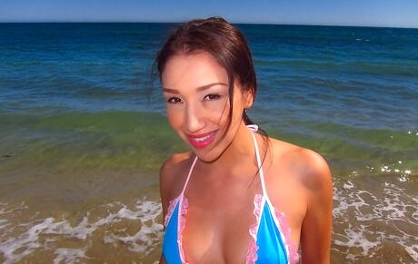 Shapely oriental brunette teen Vicki Chase baring big boobies and hot butt on the beach