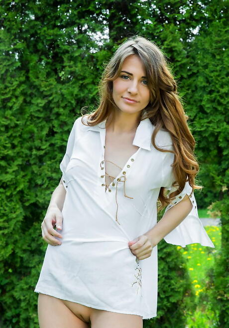 Hot dark-haired teen Olwen shows her butt and bald pussy outdoor