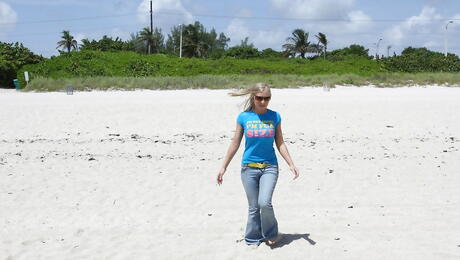 Very attractive american milf Britney Brooks revealing big boobs and undressing on the beach