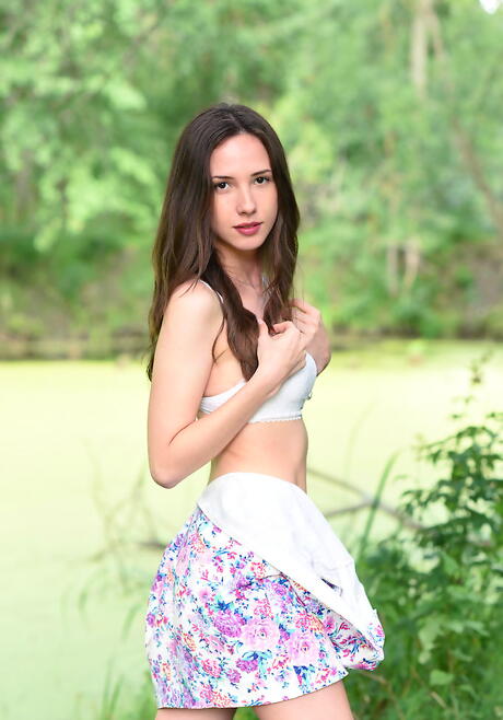 Shapely dark-haired young Dama in lingerie revealing her ass and spreading her legs outside