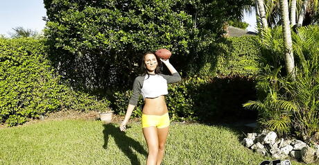 Enchanting brunette babe Alicia Tease in fancy shorts exhibits big tits and sexy butt outdoor