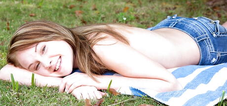 Sexy young Lizzy Bell revealing small tits and masturbating outside