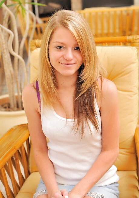 Slim american blond teen Marianna in shorts revealing big knockers and spreading her legs 