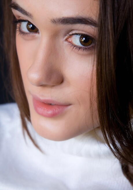 Slim young Penelope B in stockings exhibiting big boobies and shaved pussy 