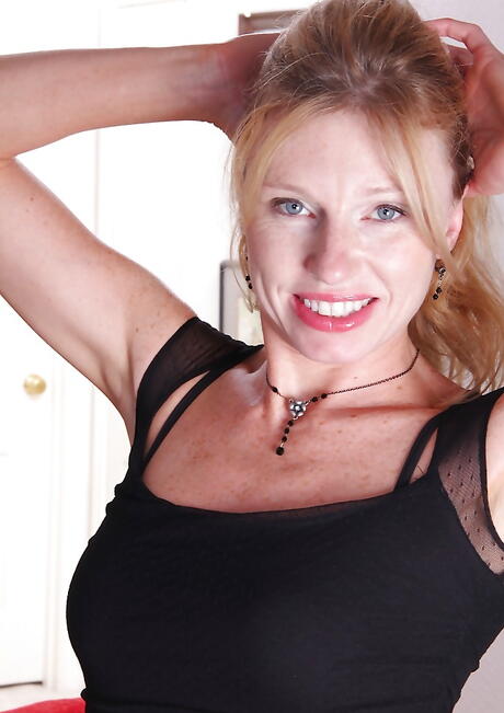 Shapely blonde milf Holly Jones in fancy pantyhose showing tiny tits and spreading her legs 