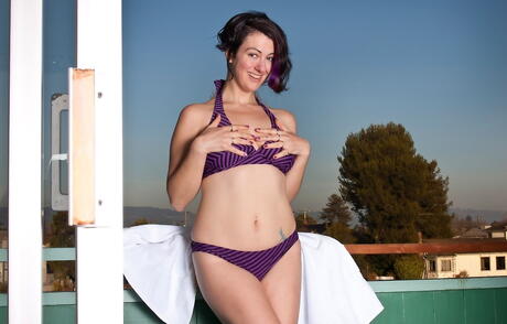 Shapely milf Sadie Lune exposes tiny tits and spreads her legs outdoor