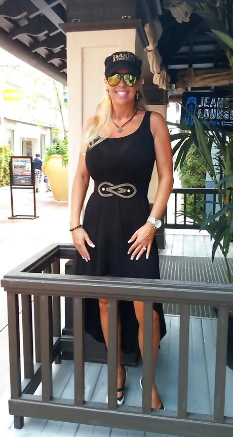 Very attractive american housewife Sandra Otterson posing in sexy glasses on camera outdoor