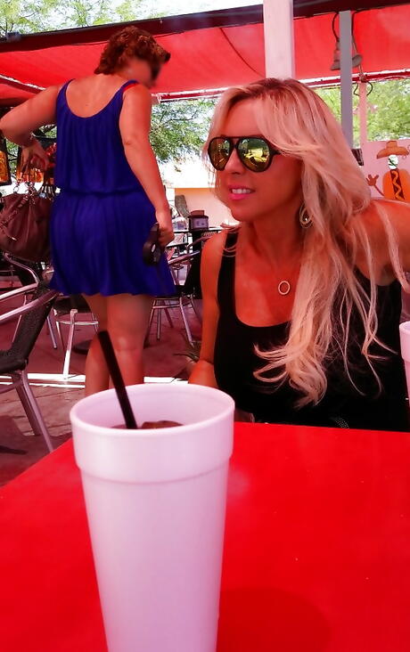 Very attractive american housewife Sandra Otterson posing in sexy glasses on camera outdoor