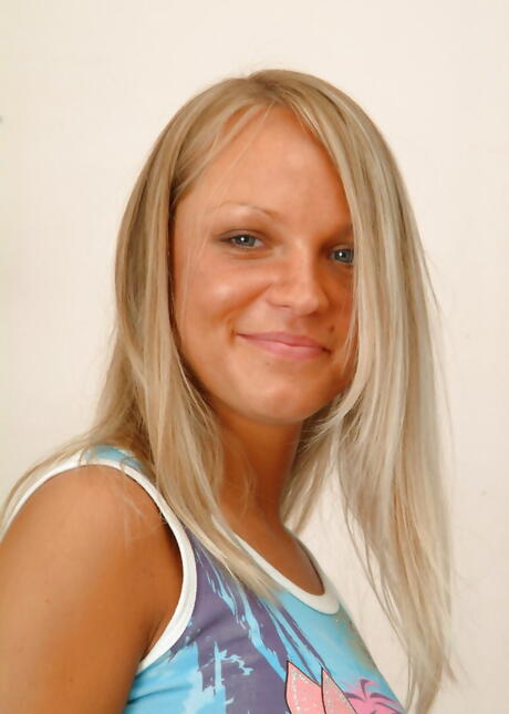 Luscious blond young Julia in skirt bares her ass 