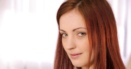 Rangy redhead young Iris Amore exposes small tits and play with sex toy 