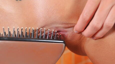 Slim cutie Melena Maria baring small tits and stuffing her pussy with a toy in the bathroom