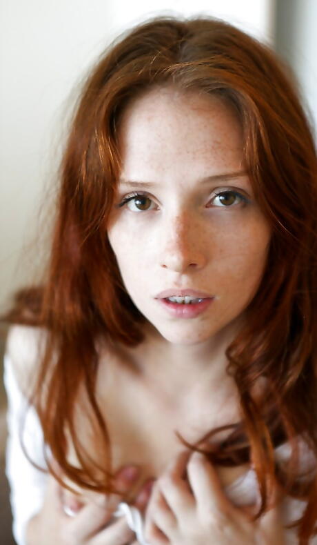 Hot redheaded babe Zazi Darling uncovering small tits and jerking off 