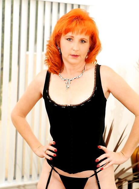 Very attractive american redhead mature Sasha Brand in hot underwear revealing tiny tits and stuffing her snatch with a toy in office