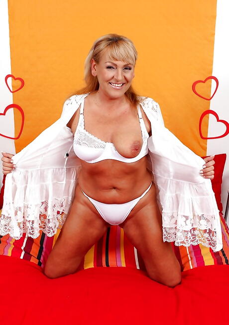 Sexy blonde older Andrea baring big titties and jerking off 