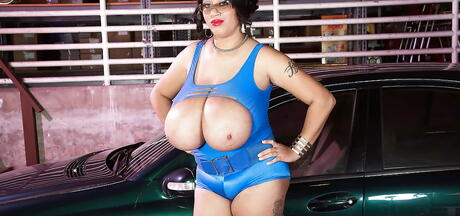 Stunning american milf Roxi Red exhibiting big boobies and jerking off outside