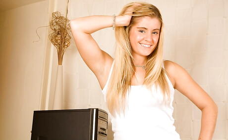 Gracile young Belle exhibits big tits and spreads her legs in office