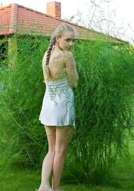 Foxy russian blonde youthful Liv A in sexy skirt exhibits tiny tits and hairy pussy outside