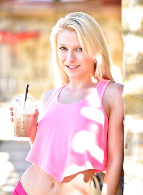 Luscious blond youthful Krystal Shay bares tiny tits and toys her twat outdoor