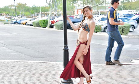 Svelte youthful Eva Celeste in fancy bikini exposing her butt and masturbating with sex toy outside