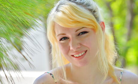 Slim blonde teen Astrid reveals big titties and shaved pussy outside