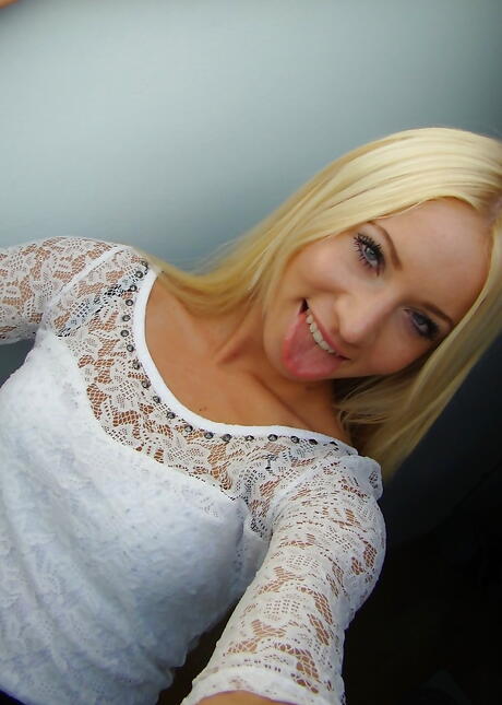 Svelte blond young Carrie in sexy underwear exhibits big tits and shaved pussy 