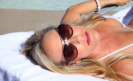 Glamorous american milf Brandi Love exhibits big boobs and vagina on the beach