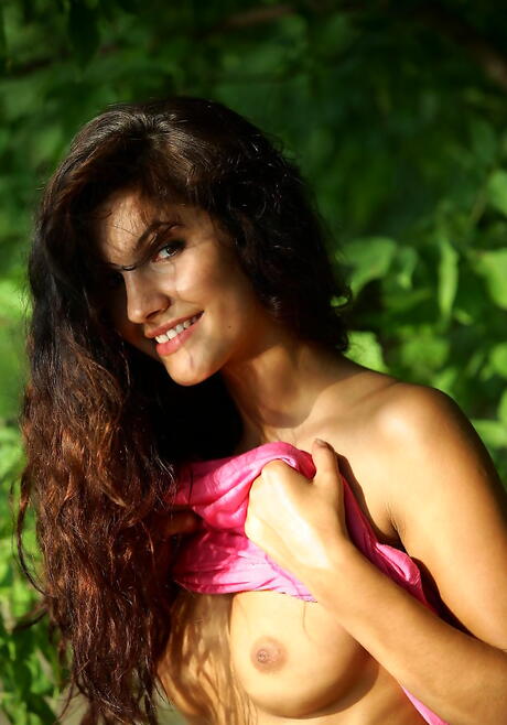 Shapely dark-haired youthful Lola B uncovering tiny tits and shaved pussy on the beach