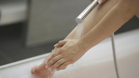 Stunning bombshell Timea Bella exposes her ass in and masturbating in shower