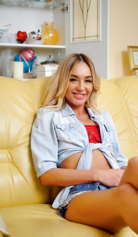 Slim blonde cutie Lola Love in shorts exposes tiny tits and plays with sex toy 