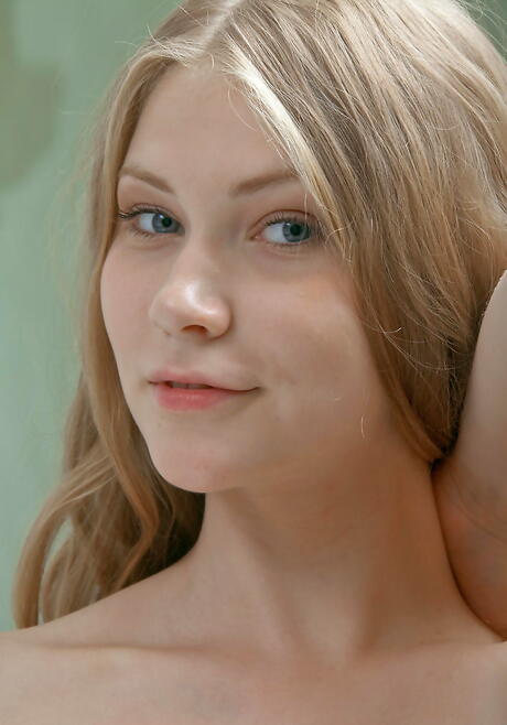 Sexy blond young Kessie A exposes small tits and spreads her legs 