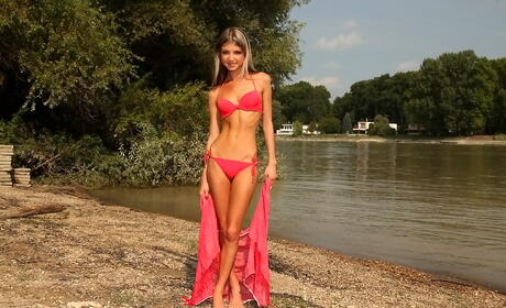 Slender russian babe Gina Gerson in fancy bikini unveils tiny tits and spreads her legs at beach