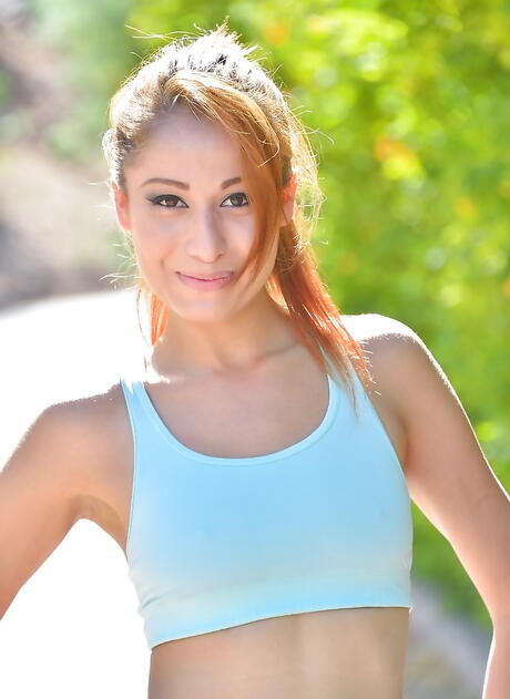 Very attractive 1989 redheaded young Lilly Evans uncovering small tits and spreading her legs outdoor