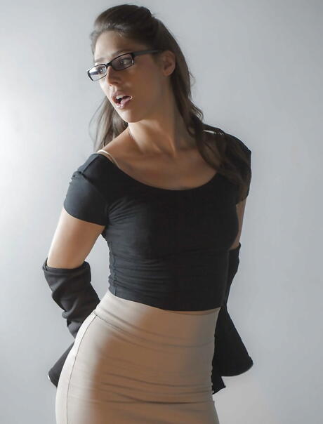 Curious brunette cutie Anna Morna in stockings revealing her butt and spreading her legs in office