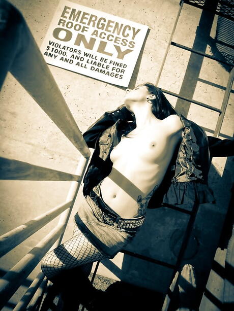 Rangy american milf Joanna Angel bares tiny tits while taking off her clothes outside