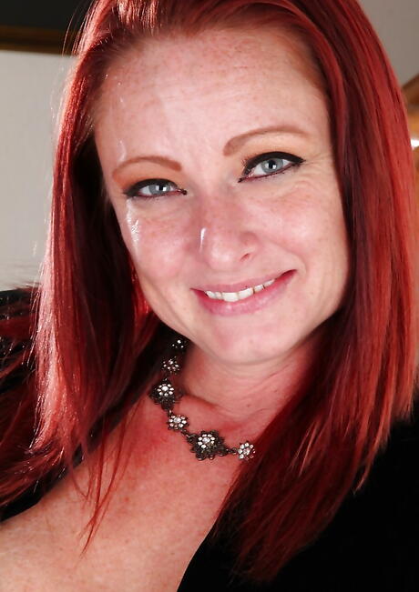 Deluxe redheaded aged Brandie Jones reveals big tits and spreads her legs 