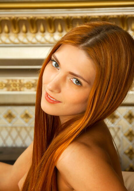 Luscious redheaded youthful Carinela reveals tiny tits and spreads her legs 