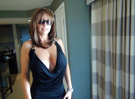 Very attractive american older Sandra Otterson in sexy skirt exposes big tits and hot ass outside