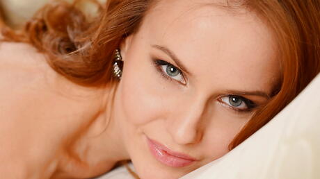 Very attractive red-haired babe Sabrina Moor in hot undies exposes her ass and nice pussy 