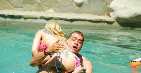 Sultry american blonde Christie Stevens exhibiting big tits and sexy ass at pool