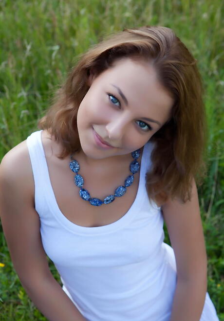 Foxy young Nikia A in fancy skirt reveals small tits and sexy ass outside