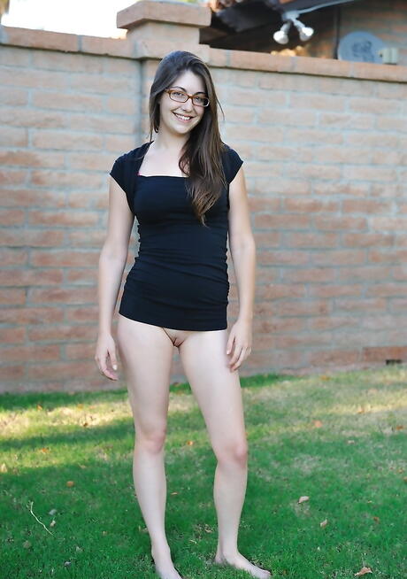 Sylphlike dark hair youthful Orianna in glasses denudes big boobs and pussy outside