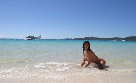 Seductive american dark hair milf Tera Patrick exhibiting big boobies and ass on the beach