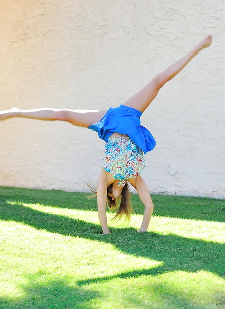 Rangy young Mali Myers in fancy skirt baring big boobies and spreading her legs outdoor