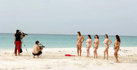 Hot american porn star Angela White baring big boobies and spreading her legs on the beach