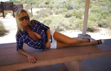 Alluring american blonde wife Sandra Otterson bares big titties and ass outdoor