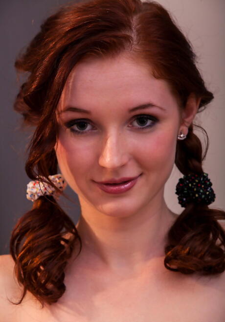 Slim red-haired youthful Leona Honey in undies exhibits her ass and bald pussy 