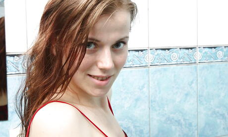 Luscious young Izabella Putine exposing small tits and masturbating in the bathroom