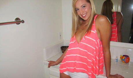 Amazing blond cutie Renae Morgan in jeans reveals her butt and spreads her legs in bathroom