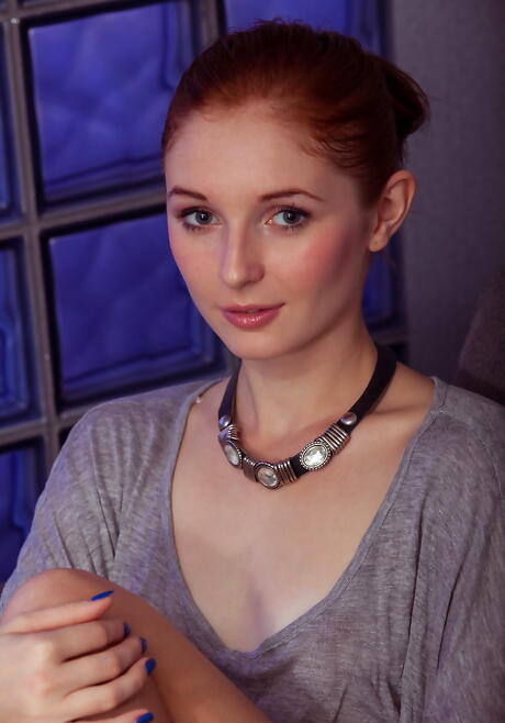 Sexy redheaded teen Leona Honey uncovers tiny tits and shaved pussy 