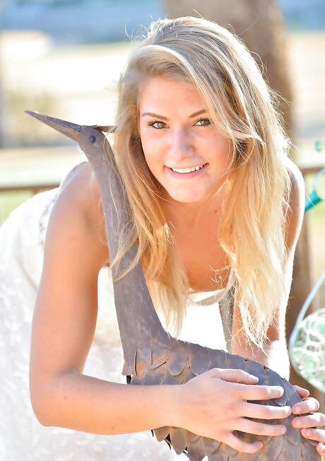 Gracile blond teen Nicky in fancy skirt bares her butt and masturbates with dildo at pool